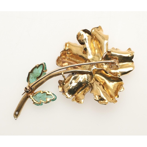 262 - A GOLD, DIAMOND AND EMERALD FLOWER BROOCH. the gold flowerhead centred with a cushion-shaped diamond... 