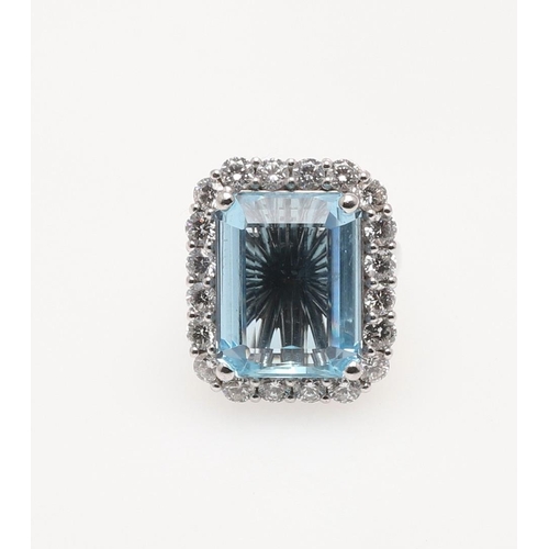 265 - AN AQUAMARINE AND DIAMOND CLUSTER RING. the step-cut aquamarine weighs approximately 12 carats and i... 