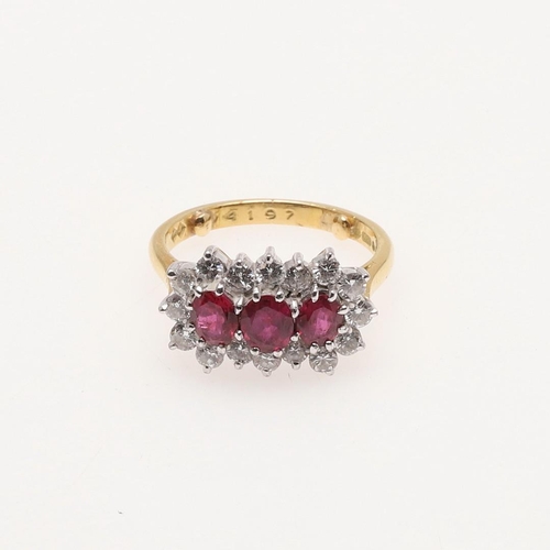 269 - A RUBY AND DIAMOND TRIPLE CLUSTER RING. the three oval-shaped rubies are set within a surround of br... 