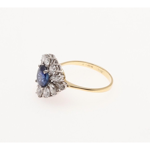 272 - A SAPPHIRE AND DIAMOND CLUSTER RING. the oval-shaped sapphire is set within a surround of marquise-c... 