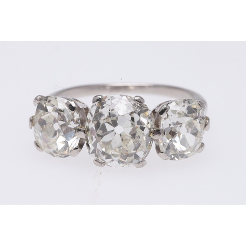 278 - A DIAMOND THREE STONE RING. mounted with three cushion-shaped old cut diamonds measuring approximate... 