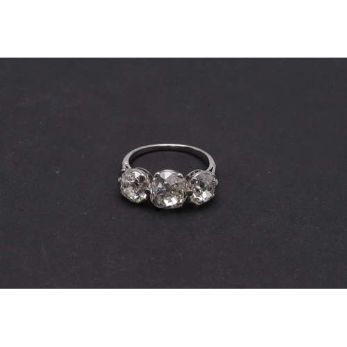 278 - A DIAMOND THREE STONE RING. mounted with three cushion-shaped old cut diamonds measuring approximate... 