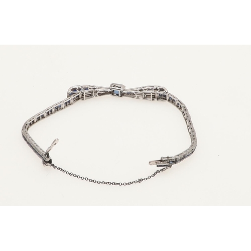 280 - AN ART DECO SAPPHIRE AND DIAMOND BRACELET. designed as a stylised bow set with a rectangular-shaped ... 