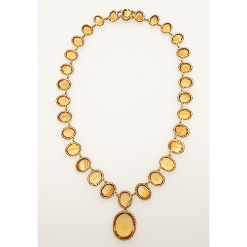 282 - A VICTORIAN CITRINE AND GOLD RIVIERE NECKLACE. mounted with graduated oval-shaped citrines in gold r... 