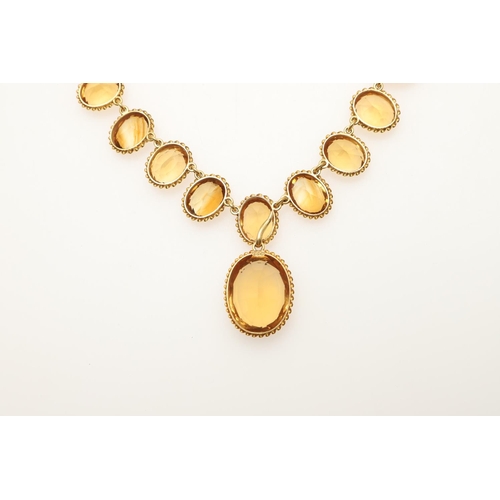 282 - A VICTORIAN CITRINE AND GOLD RIVIERE NECKLACE. mounted with graduated oval-shaped citrines in gold r... 