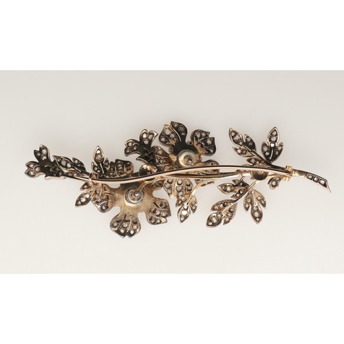 286 - A VICTORIAN DIAMOND AND PEARL FOLIATE SPRAY BROOCH. the two flowerheads set en tremblant and each ce... 