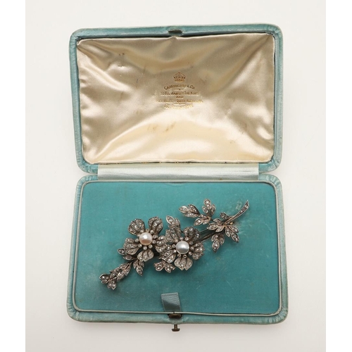 286 - A VICTORIAN DIAMOND AND PEARL FOLIATE SPRAY BROOCH. the two flowerheads set en tremblant and each ce... 