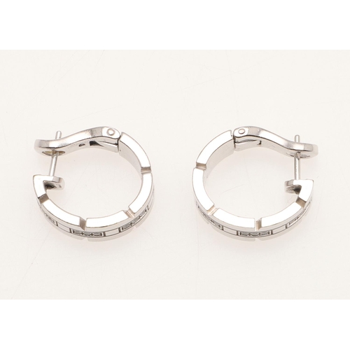 288 - A PAIR OF DIAMOND AND 18CT WHITE GOLD HOOP EARRINGS BY CARTIER. mounted with sections of circular-cu... 