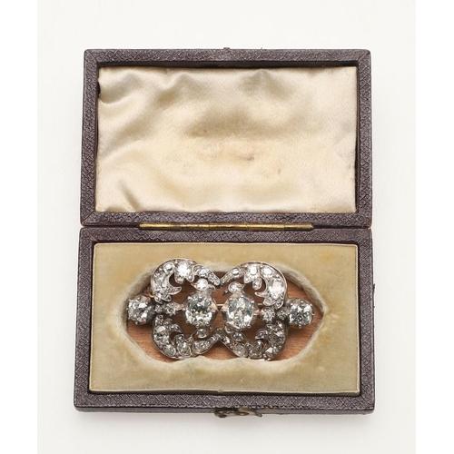 290 - A VICTORIAN DIAMOND BROOCH. the foliate openwork mount centred with two cushion-shaped diamonds in c... 