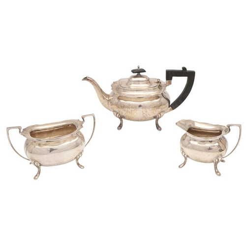 42 - AN EARLY 20TH CENTURY THREE-PIECE SILVER TEA SET. with rounded rectangular bodies, angular handles a... 