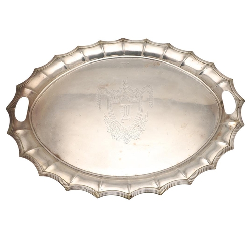 43 - A LATE VICTORIAN TWO-HANDLED SILVER TRAY. of shaped oval outline, with a reeded border and initialle... 