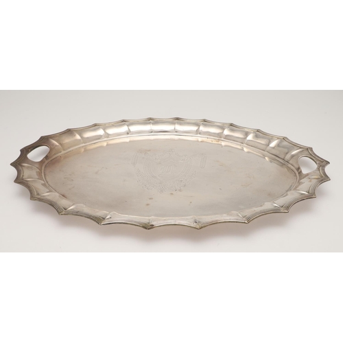 43 - A LATE VICTORIAN TWO-HANDLED SILVER TRAY. of shaped oval outline, with a reeded border and initialle... 