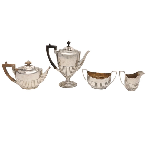 50 - A VICTORIAN FOUR-PIECE SILVER TEA & COFFEE SERVICE. oval form, with angular handles and fluted lower... 