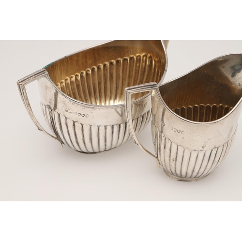 50 - A VICTORIAN FOUR-PIECE SILVER TEA & COFFEE SERVICE. oval form, with angular handles and fluted lower... 