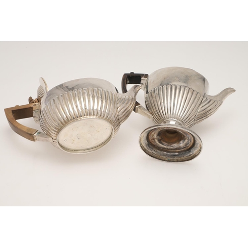 50 - A VICTORIAN FOUR-PIECE SILVER TEA & COFFEE SERVICE. oval form, with angular handles and fluted lower... 