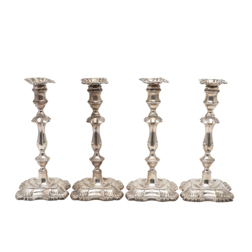 54 - A SET OF FOUR LATE VICTORIAN SILVER CANDLESTICKS. on shaped square bases (loaded), with knopped stem... 