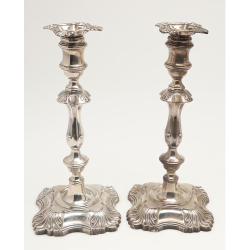 54 - A SET OF FOUR LATE VICTORIAN SILVER CANDLESTICKS. on shaped square bases (loaded), with knopped stem... 