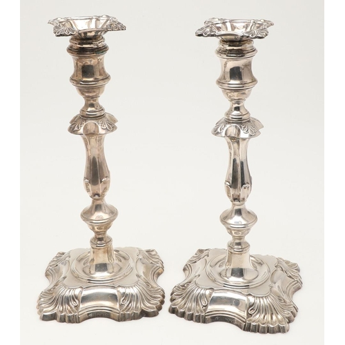 54 - A SET OF FOUR LATE VICTORIAN SILVER CANDLESTICKS. on shaped square bases (loaded), with knopped stem... 