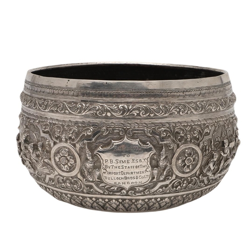 57 - A LATE 19TH/ EARLY 20TH CENTURY BURMESE SILVER RICE BOWL. embossed and chased around the sides in re... 