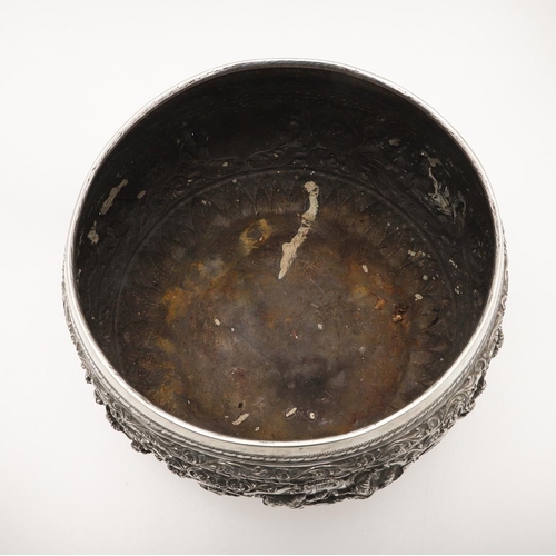 57 - A LATE 19TH/ EARLY 20TH CENTURY BURMESE SILVER RICE BOWL. embossed and chased around the sides in re... 