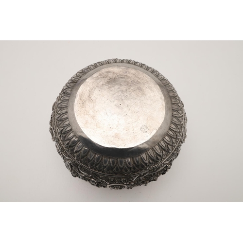 57 - A LATE 19TH/ EARLY 20TH CENTURY BURMESE SILVER RICE BOWL. embossed and chased around the sides in re... 