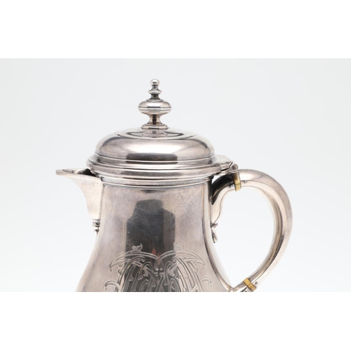 61 - A GEORGE V SILVER HOT WATER JUG. of baluster form, with a scroll handle, knop finial and raised on a... 