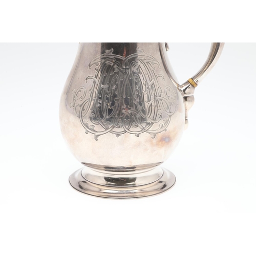 61 - A GEORGE V SILVER HOT WATER JUG. of baluster form, with a scroll handle, knop finial and raised on a... 