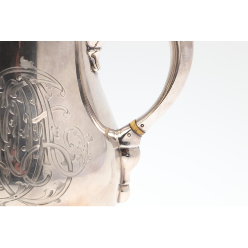 61 - A GEORGE V SILVER HOT WATER JUG. of baluster form, with a scroll handle, knop finial and raised on a... 