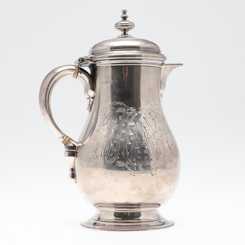 61 - A GEORGE V SILVER HOT WATER JUG. of baluster form, with a scroll handle, knop finial and raised on a... 