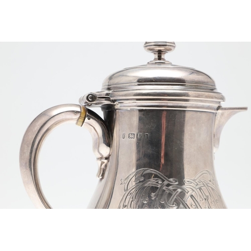 61 - A GEORGE V SILVER HOT WATER JUG. of baluster form, with a scroll handle, knop finial and raised on a... 