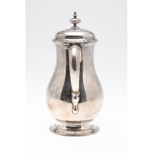 61 - A GEORGE V SILVER HOT WATER JUG. of baluster form, with a scroll handle, knop finial and raised on a... 