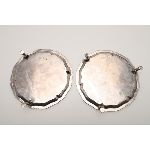 62 - A PAIR OF GEORGE III SMALL SILVER SALVERS OR WAITERS. of shaped circular outline, with gadrooned bor... 