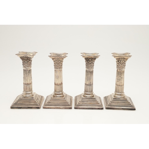 65 - TWO PAIRS OF LATE VICTORIAN SILVER CANDLESTICKS. with bead borders, fluted columns and on stepped sq... 