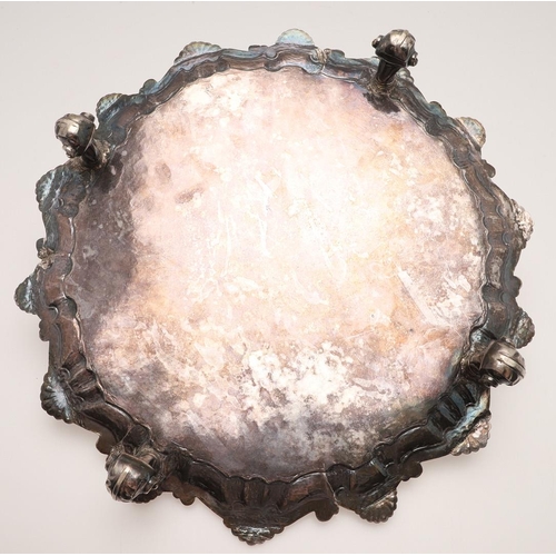 69 - A LATE 18TH/ EARLY 19TH CENTURY SILVER SALVER. of shaped circular outline, with a husk and scroll bo... 