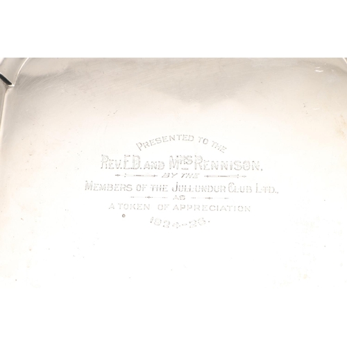 70 - A GEORGE V SILVER SALVER. of shaped square outline, with incurved corners, a moulded border and on f... 