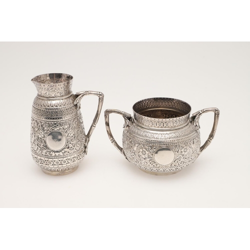 72 - A LATE VICTORIAN FOUR-PIECE SILVER TEA & COFFEE SERVICE. of circular form, with naturalistic handles... 