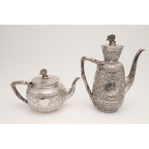 72 - A LATE VICTORIAN FOUR-PIECE SILVER TEA & COFFEE SERVICE. of circular form, with naturalistic handles... 