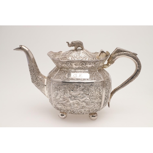 73 - AN INDIAN FOUR-PIECE SILVER TEA & COFFEE SERVICE. of panelled oval form, with elephant finials, scro... 