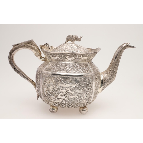 73 - AN INDIAN FOUR-PIECE SILVER TEA & COFFEE SERVICE. of panelled oval form, with elephant finials, scro... 