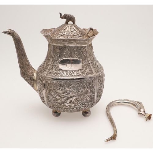 73 - AN INDIAN FOUR-PIECE SILVER TEA & COFFEE SERVICE. of panelled oval form, with elephant finials, scro... 