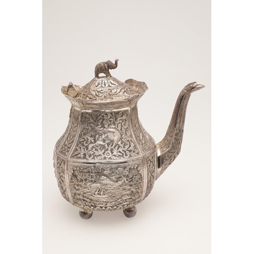 73 - AN INDIAN FOUR-PIECE SILVER TEA & COFFEE SERVICE. of panelled oval form, with elephant finials, scro... 