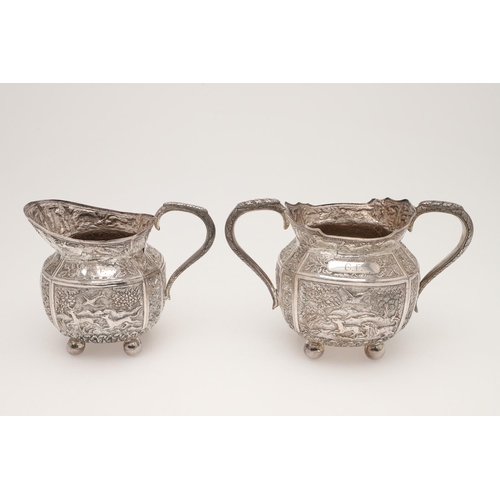 73 - AN INDIAN FOUR-PIECE SILVER TEA & COFFEE SERVICE. of panelled oval form, with elephant finials, scro... 