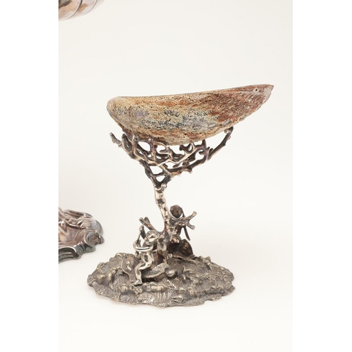 75 - AN EDWARDIAN SILVER PLATED CENTREPIECE. on a foliate scrolling base, with a cherubic figure column s... 