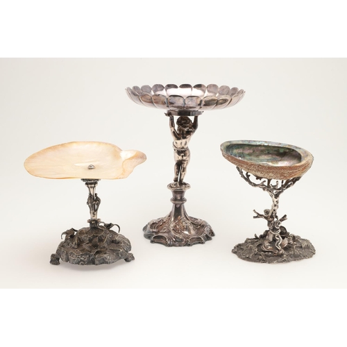 75 - AN EDWARDIAN SILVER PLATED CENTREPIECE. on a foliate scrolling base, with a cherubic figure column s... 