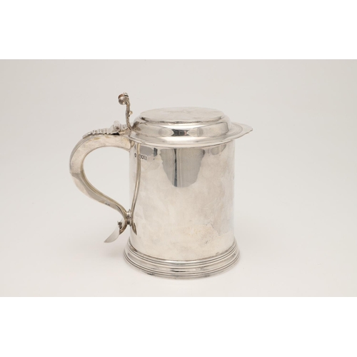 77 - A LATE VICTORIAN SILVER TANKARD. in the style of a late 17th century example, crested & inscribed 