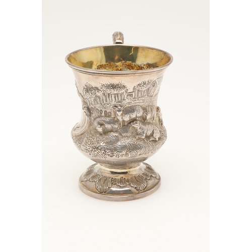 79 - A WILLIAM IV SILVER CHISTENING MUG. of campana form, with a leaf-capped 'S'-scroll handle and decora... 