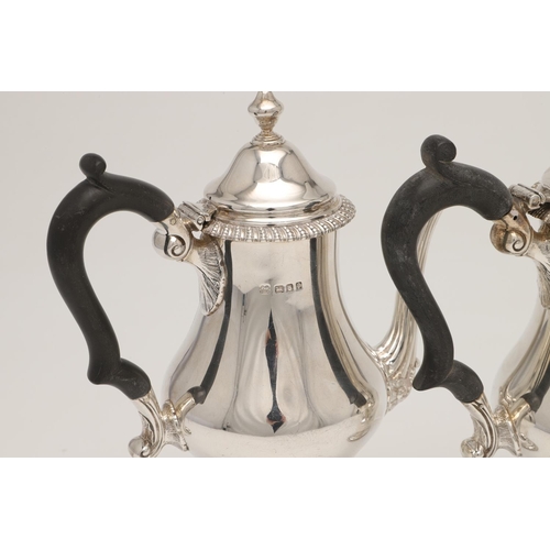 83 - A PAIR OF GEORGE V SILVER CAFE AU LAIT POTS. with bellied bodies, textured borders, 'S'-scroll handl... 