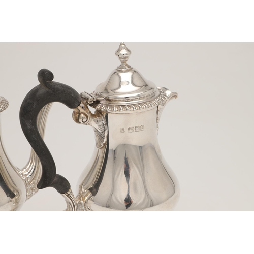 83 - A PAIR OF GEORGE V SILVER CAFE AU LAIT POTS. with bellied bodies, textured borders, 'S'-scroll handl... 