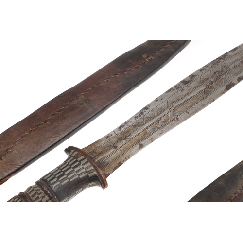 108 - A NEAR IDENTICAL PAIR OF SUDANESE KNIVES AND SCABBARDS. The two blades 32 cm and 30 cm, with curved ... 