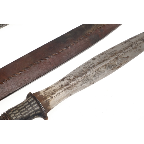 108 - A NEAR IDENTICAL PAIR OF SUDANESE KNIVES AND SCABBARDS. The two blades 32 cm and 30 cm, with curved ... 